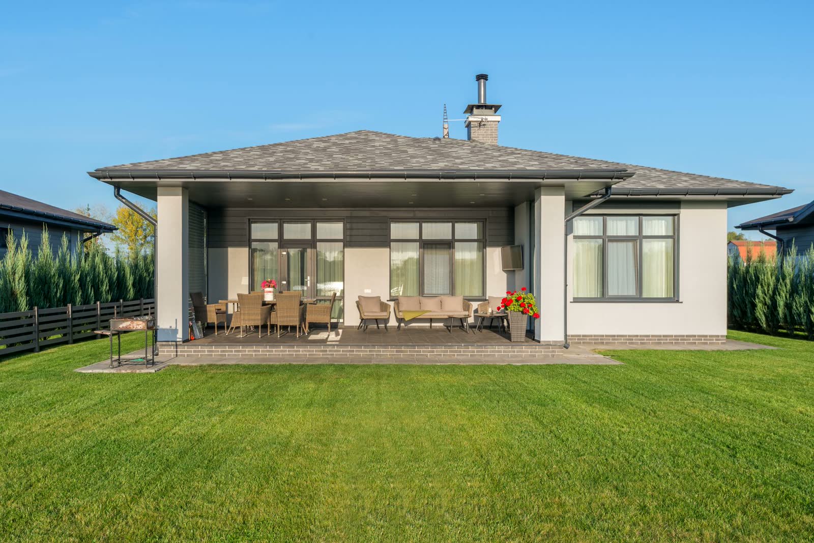 After: lush renovated backyard with new lawn and patio