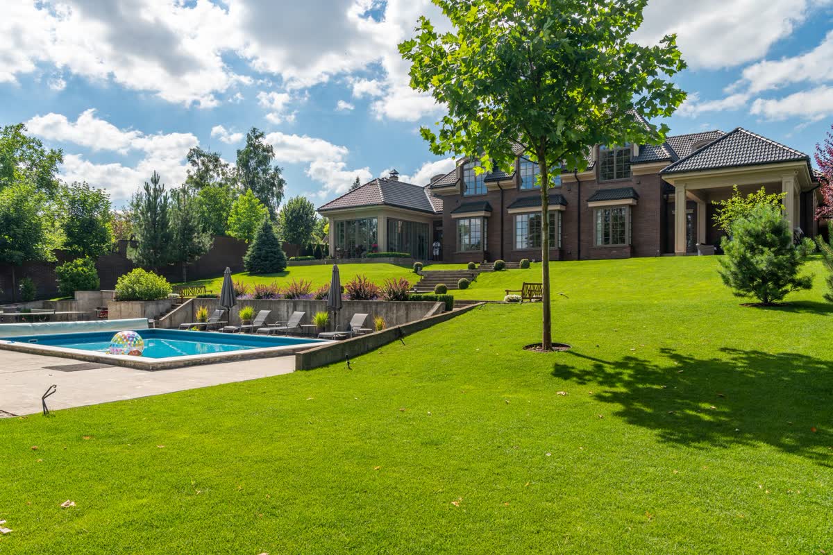 Pool surrounded by manicured lawn